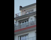 Two girls white clothes  stand on balcony