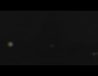 Rapid lightning flashes over neighborhood tree silhouette 