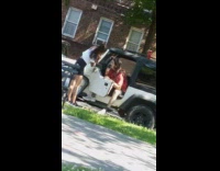 Guy shaves his beard while sitting in car with door open