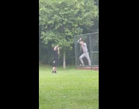 Man in zebra patterned outfit leans on the fence