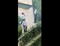 Guy poses for photo in outdoor garden