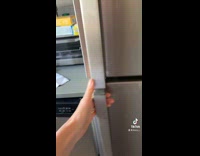 Woman shows yellow pickle jar broken lid 