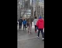 Guy holds rat costume mask under arm 
