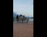 Woman blue pants handstand metal railings balcony