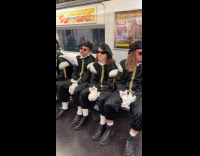 Guys dressed up as prince on train