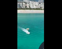 Parachute attached to boat on the beach
