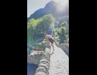 Man black shorts jump dive from bridge