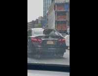 Car holds car part together with rope 