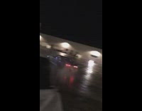 Blue car drifts across empty parking lot 