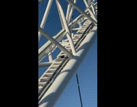 Two Raven steps up and climbs the stairs of the bridge 