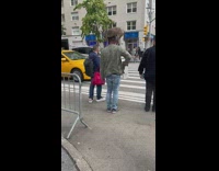 Guy crosses street with dog on shoulders 