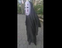 Person at park dressed as no face from spirited away 
pt. 2