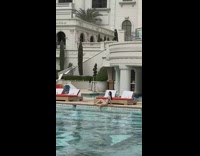 Girl brown bikini sit poolside mansion bed