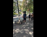 Man walks with dog balance on shoulder