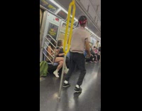 Guys do performance on subway while man holds computer