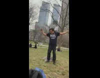 Guy standing on park grass sings picnic 