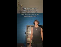 Guy black shirt standing in front of blue wall 