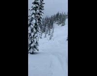 Snowmobile Goes Down the Snowy Steep Slope