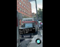 Art galleries behind trucks on the street