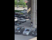 Two men in an animal costume hugs at the parking lot