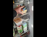 Guy pours melted cheese in plastic container