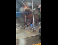 Guy hunches back over and moves arms on sidewalk like a zombie walking dead