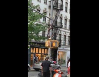 Guy climbs down pole while balancing basketball 