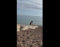 Woman onesie hand behind head beach stairs