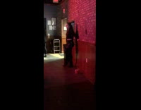 Girl black jeans shirt red brick wall club