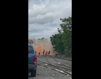 Video shoot on railway with orange smoke