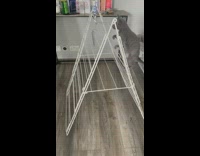 Kitten climbs drying rack to get balloon