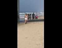 Woman white shorts dance tiktok beach tripod