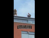 Two girls rooftop quarantine photoshoot brick building 
