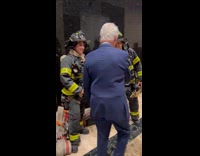 Bill Clinton greet firefighters in the building