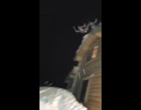 slow motion man jumps from roof to pile of snow