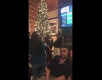 Guy poker face girls near christmas tree