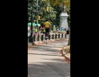 Guy rides pogo stick bouncing at park