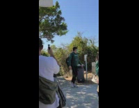 Shirtless buff guy stand on pole trashcan