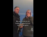 Woman swipes credit card in front of man