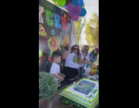 Kid gets mad after face is pushed into cake 