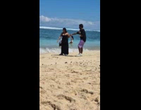 Collab IITW - Woman black dress hold hands with boyfriend beach