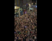People clapping in unison at street filled block party