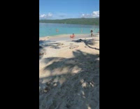 Guy black speedo sits lays beach shore 