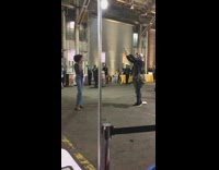 Busy convention girl poses with beer