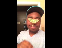 Green moth on face 