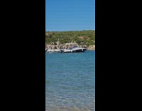 Man in briefs imitates the pose of the other man at the beach