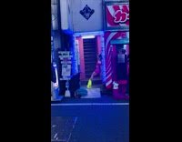 Woman pink leopard outfit lean on stairway wall