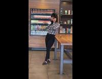 Woman snake print sleeves selfie inside starbucks