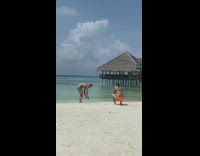 Man does two handstands on beach for picture