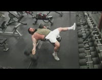 Buff guy lays down on bench to bench press and drops heavy dumbbell weights on the ground at gym